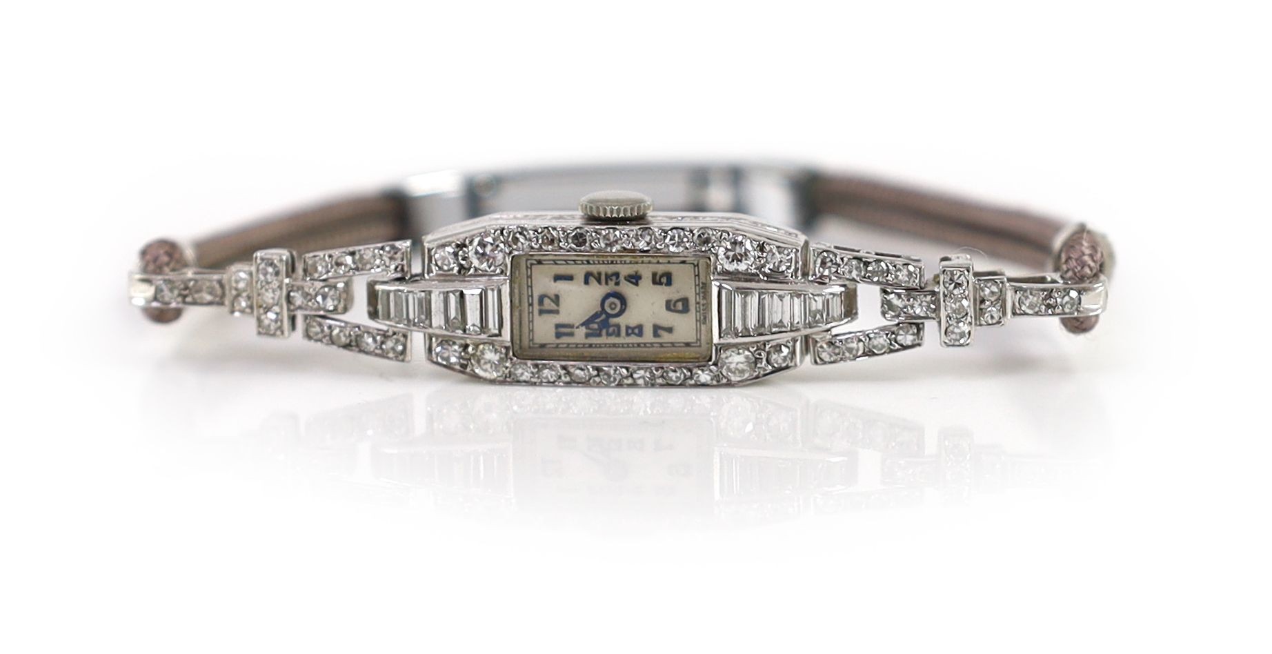A lady's platinum, round and baguette cut diamond set rectangular manual wind cocktail watch
